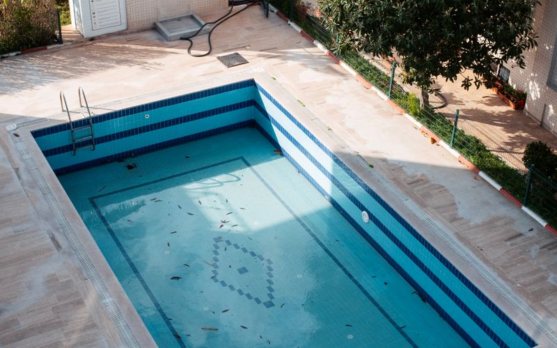 A drained, tiled swimming pool seen from above